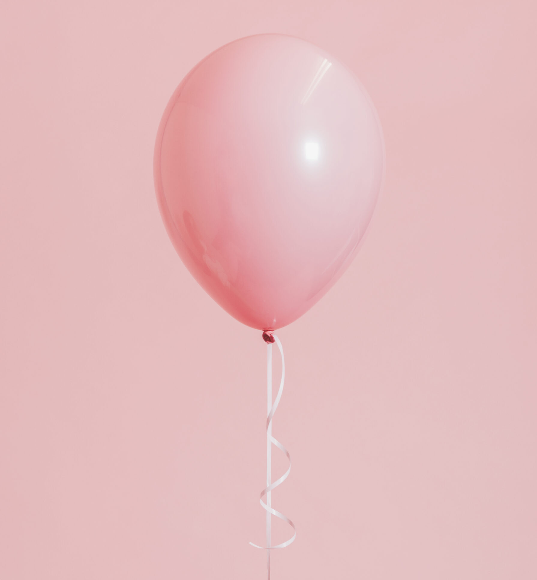 Woman holding a pink balloon